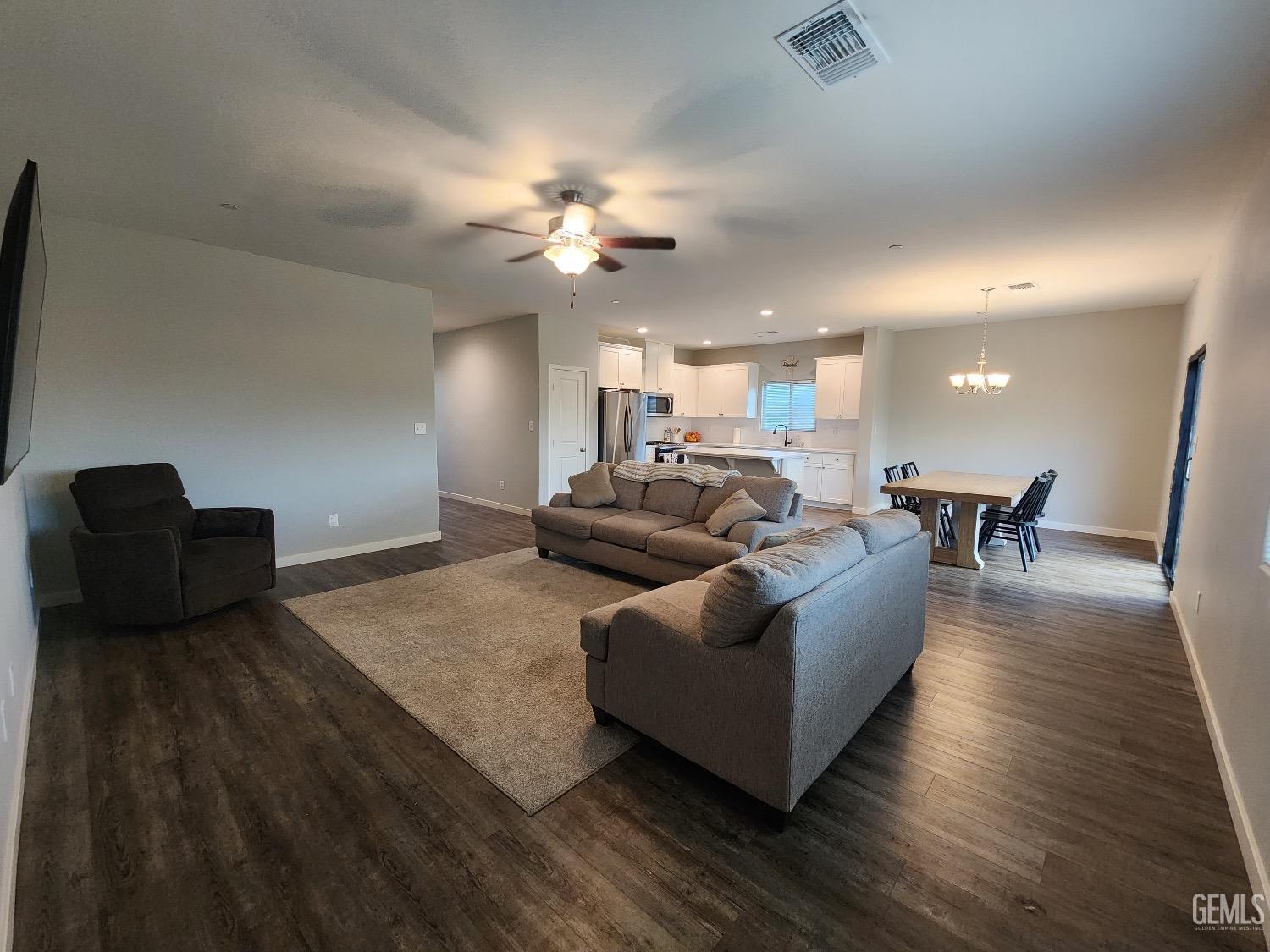 Undisclosed Address Bakersfield, CA 93307 - Photo 4 of 11 a living room with furniture and a wooden floor