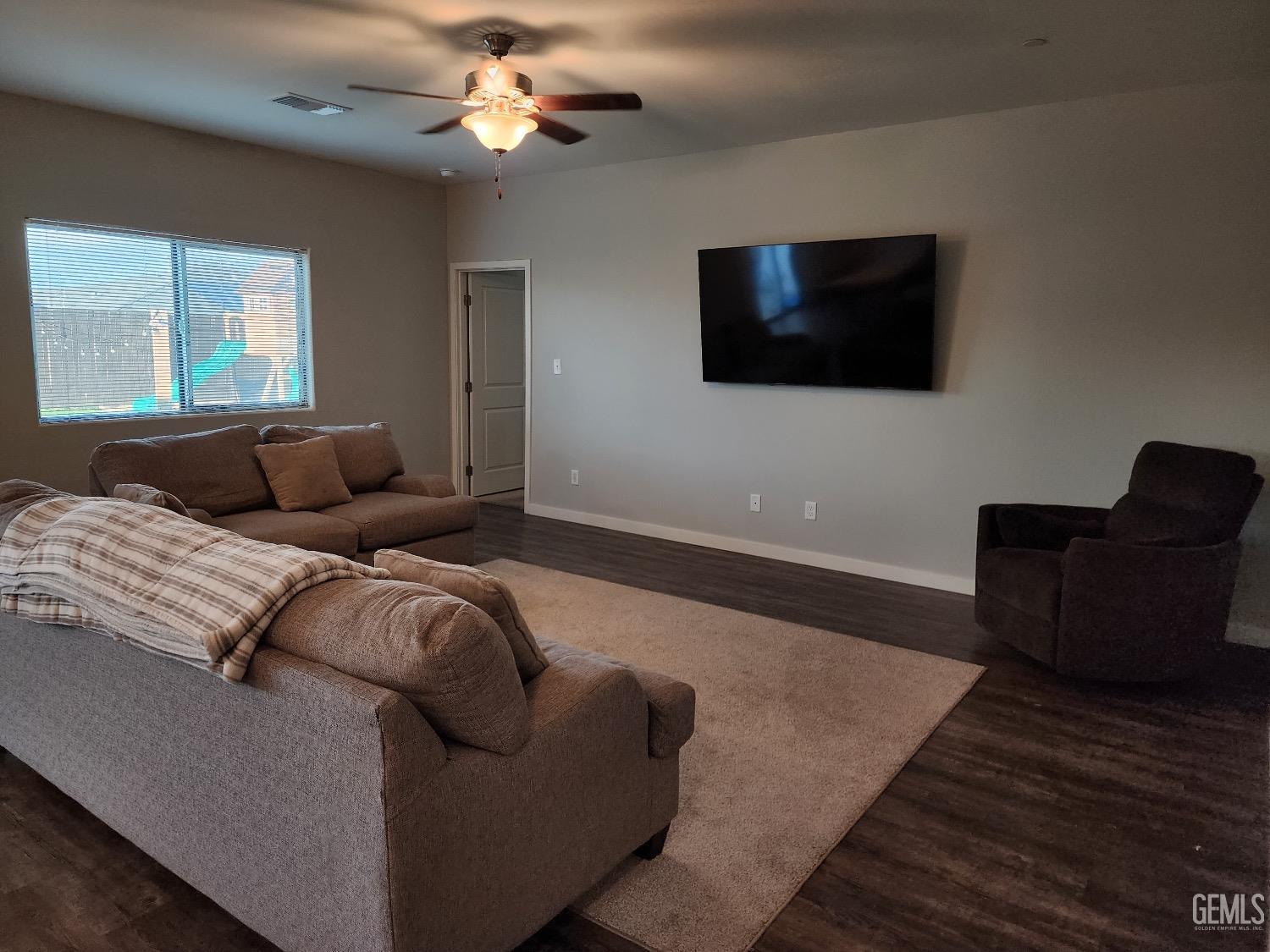Undisclosed Address Bakersfield, CA 93307 - Photo 5 of 11 a living room with furniture and a flat screen tv
