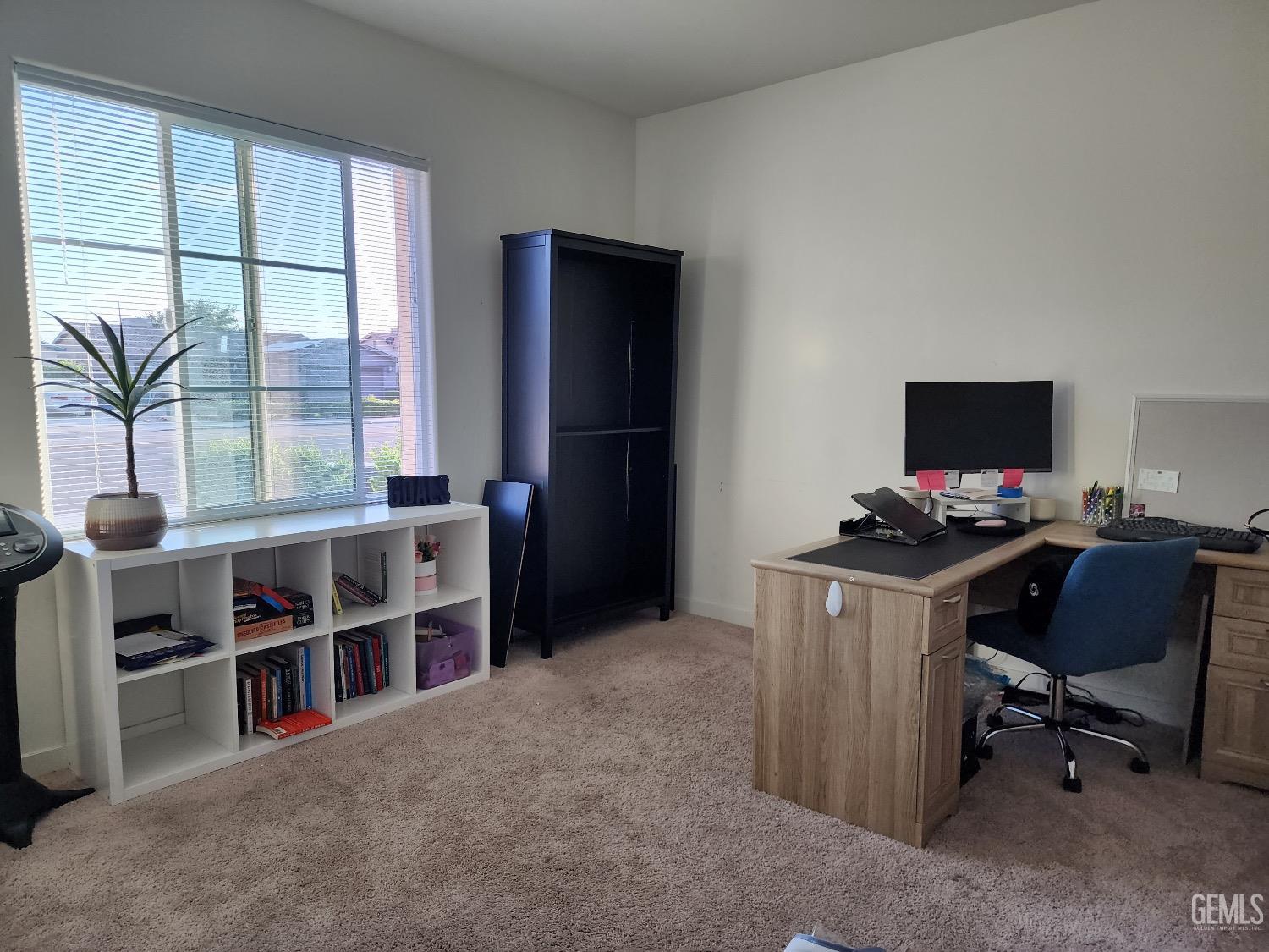 Undisclosed Address Bakersfield, CA 93307 - Photo 6 of 11 a view of a workspace with furniture and a window