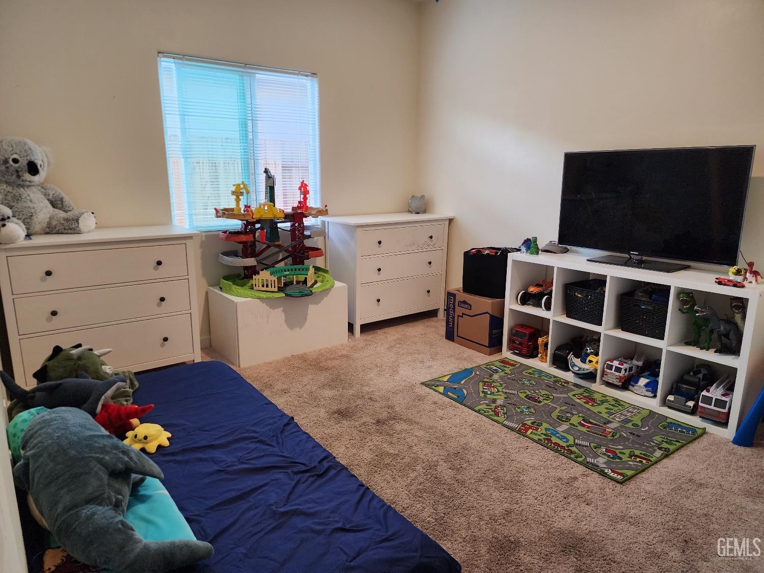 Undisclosed Address Bakersfield, CA 93307 - Photo 7 of 11 a living room with furniture and a flat screen tv