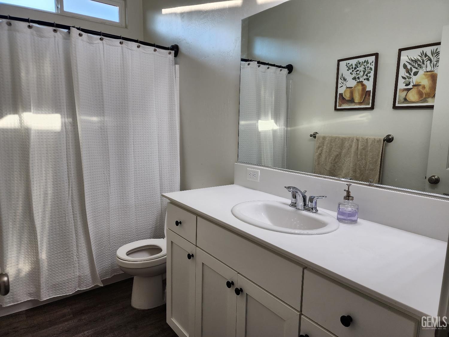 Undisclosed Address Bakersfield, CA 93307 - Photo 8 of 11 a bathroom with a granite countertop sink toilet and shower