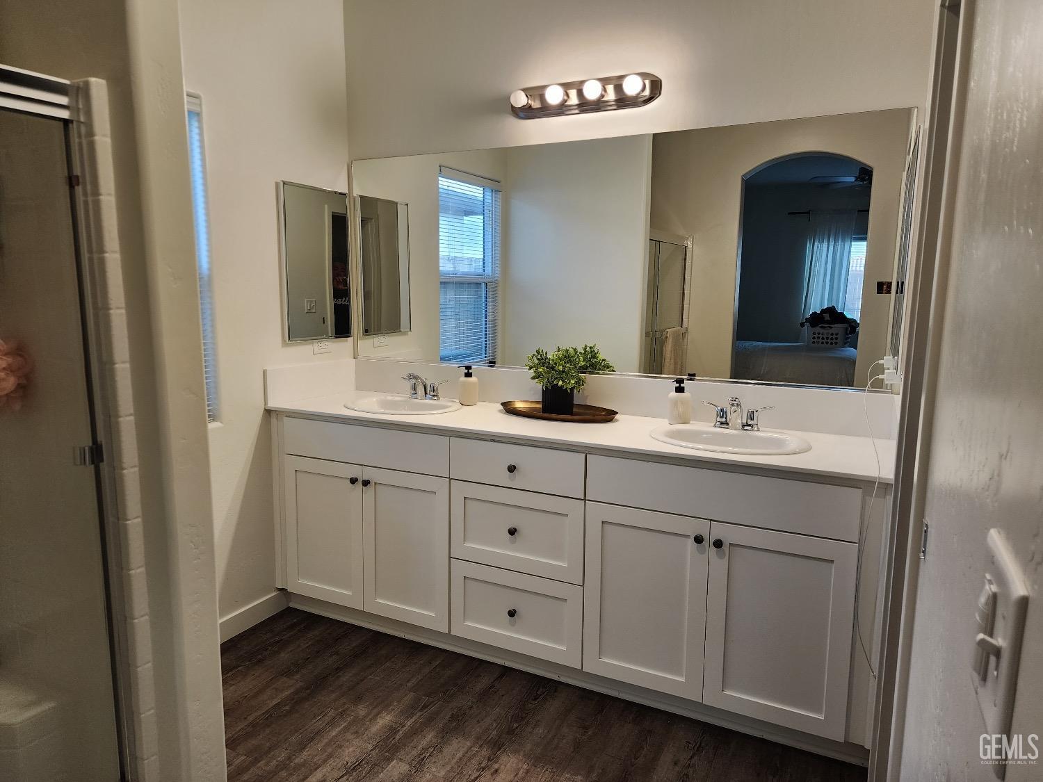 Undisclosed Address Bakersfield, CA 93307 - Photo 10 of 11 a bathroom with a double vanity sink and a mirror