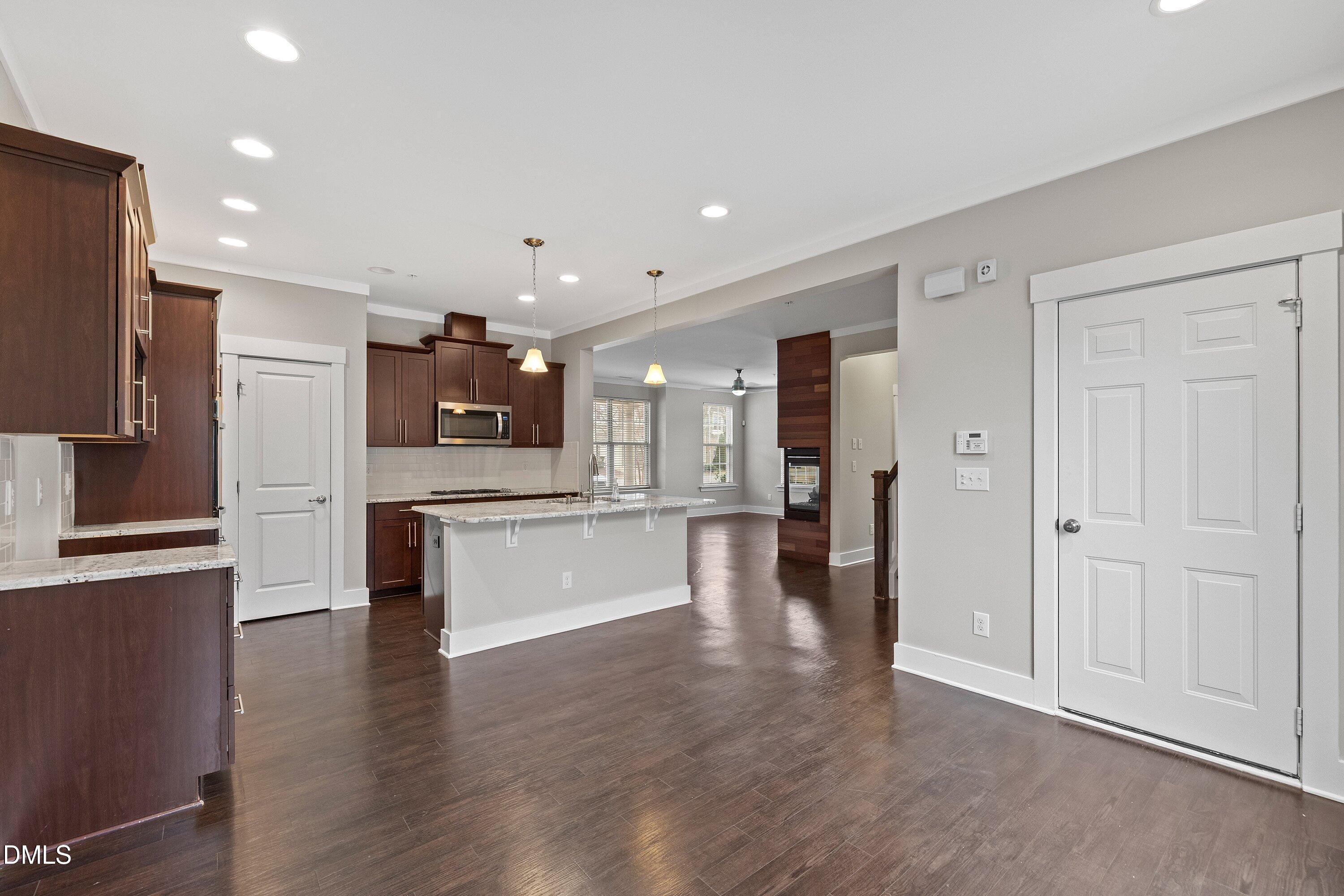 9903 Remedios Walk Raleigh, NC 27617 - Photo 14 of 53 a large kitchen with a large counter top space stainless steel appliances and cabinets