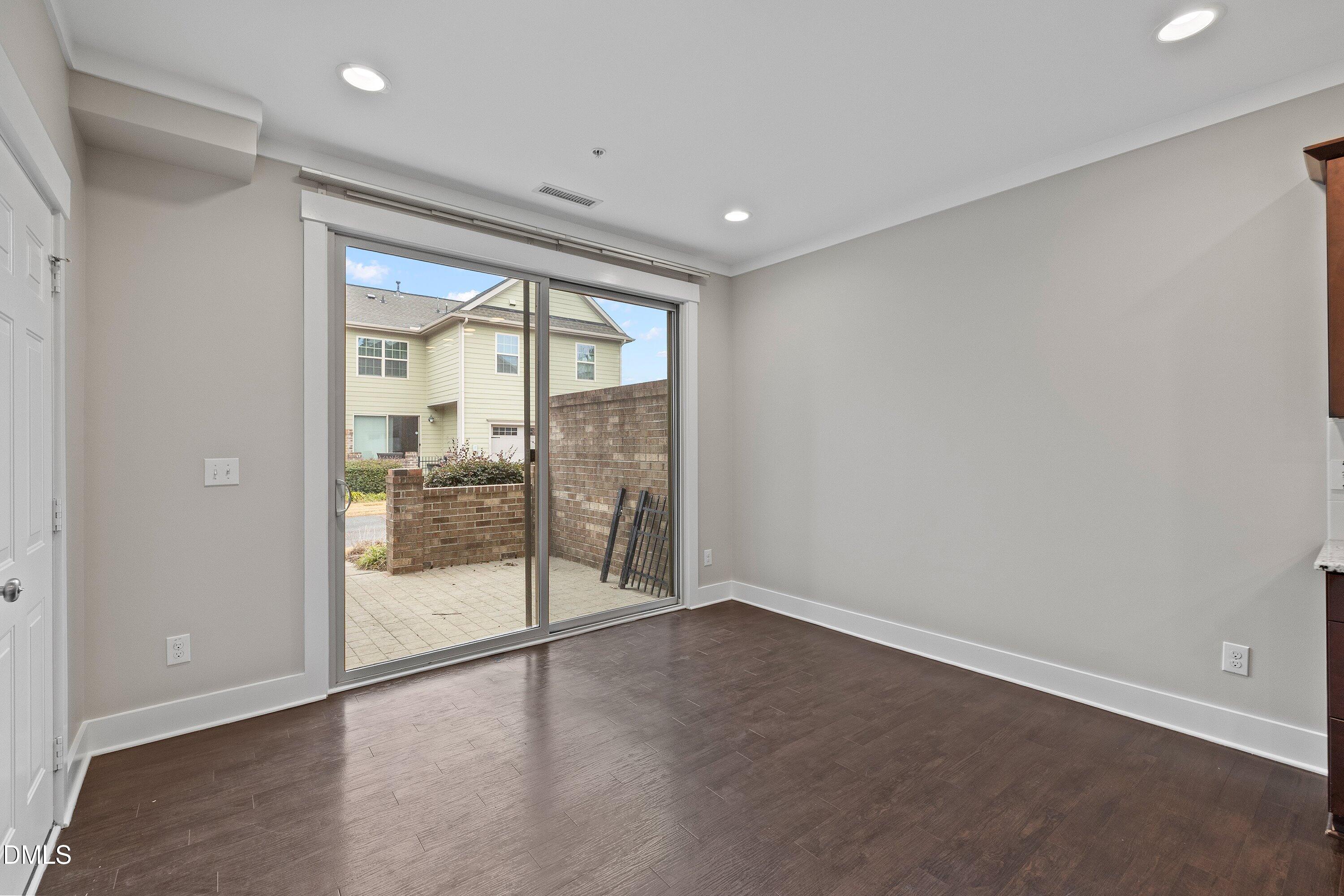 9903 Remedios Walk Raleigh, NC 27617 - Photo 22 of 53 an empty room with wooden floor and door
