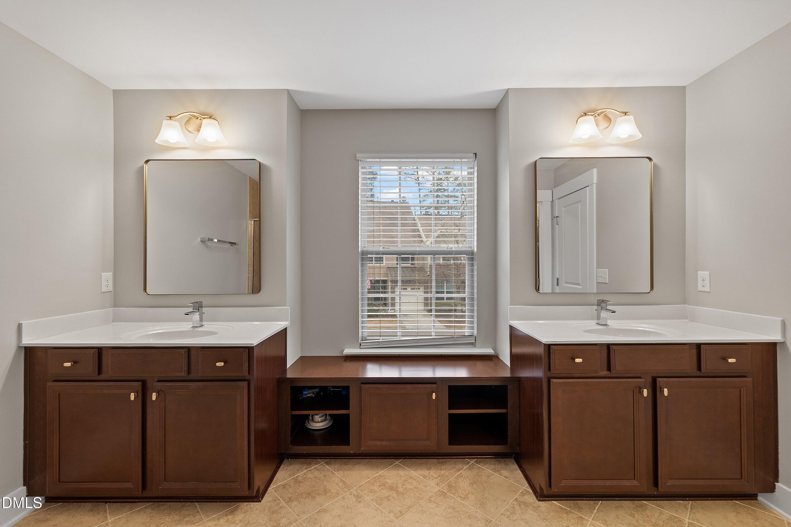 9903 Remedios Walk Raleigh, NC 27617 - Photo 36 of 53 a spacious bathroom with a granite countertop double vanity sink a mirror and a bathtub