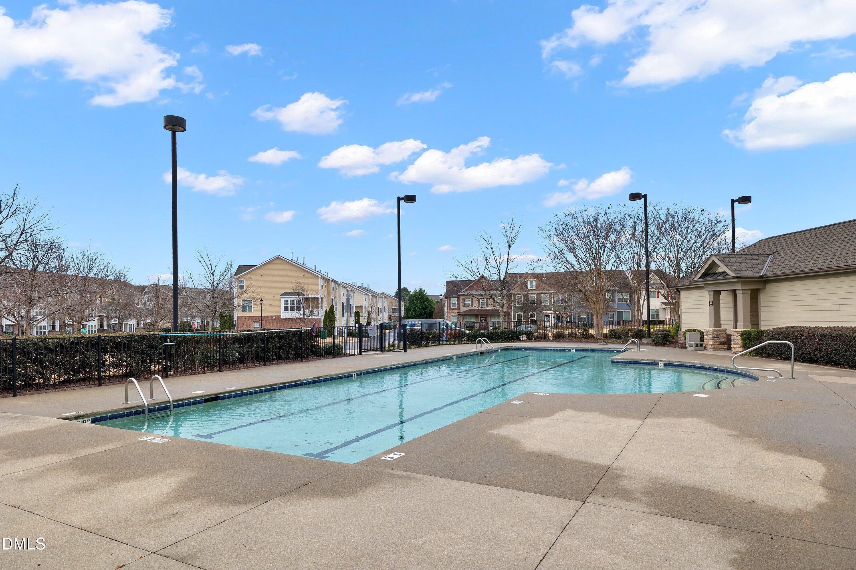 9903 Remedios Walk Raleigh, NC 27617 - Photo 50 of 53 a view of a swimming pool with a chair and tables