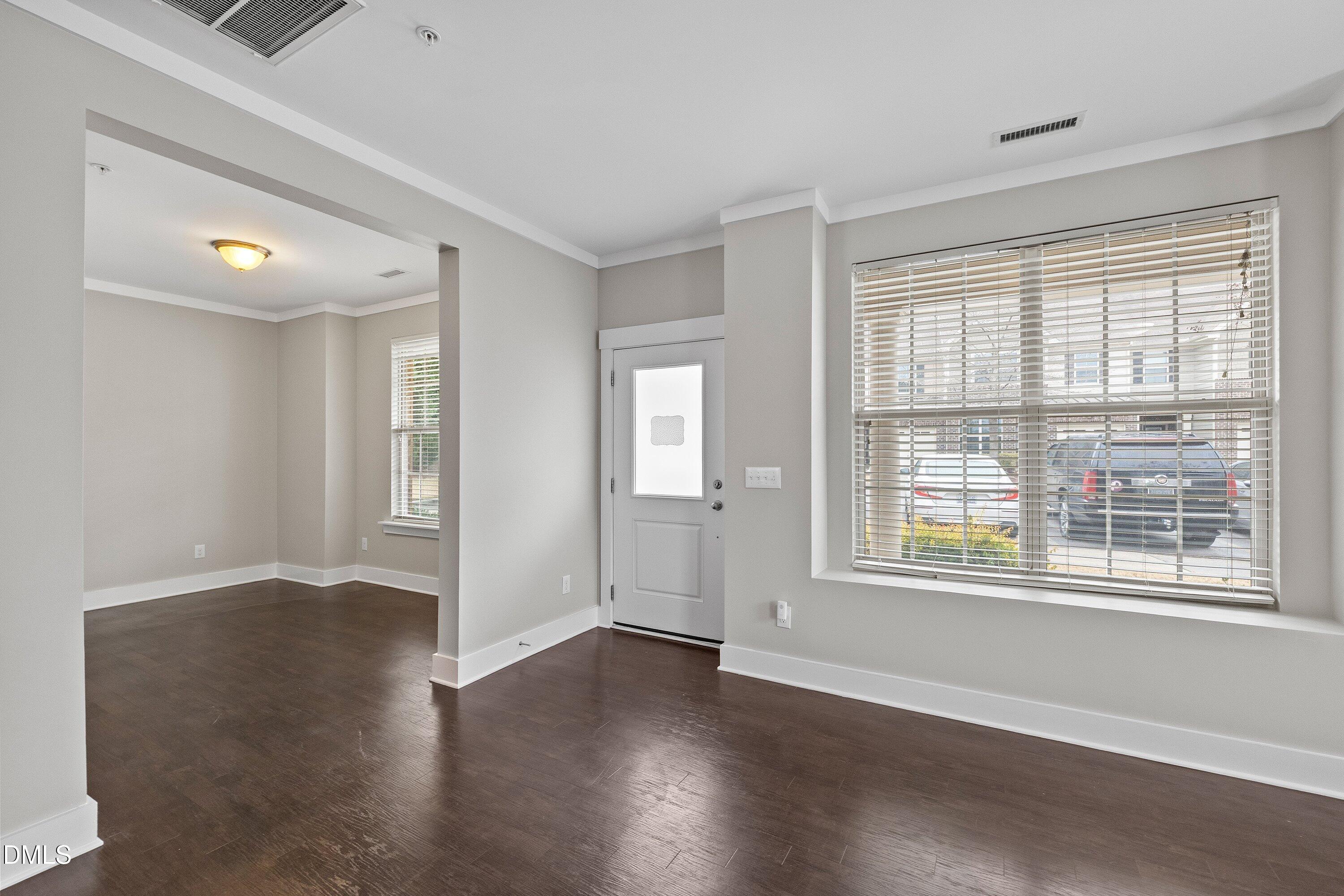 9903 Remedios Walk Raleigh, NC 27617 - Photo 7 of 53 a view of an empty room with wooden floor and a window