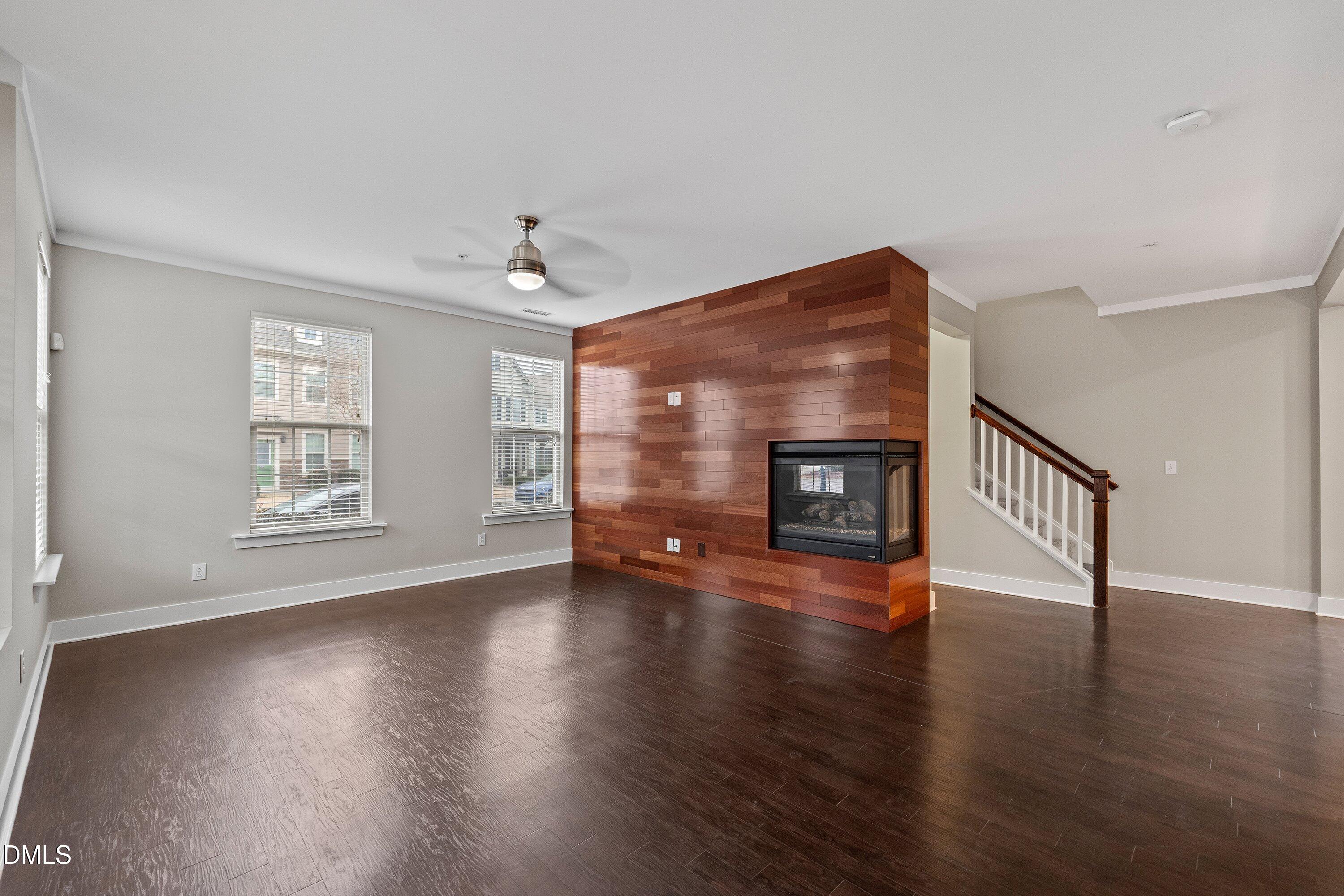 9903 Remedios Walk Raleigh, NC 27617 - Photo 10 of 53 a view of empty room with wooden floor and fireplace
