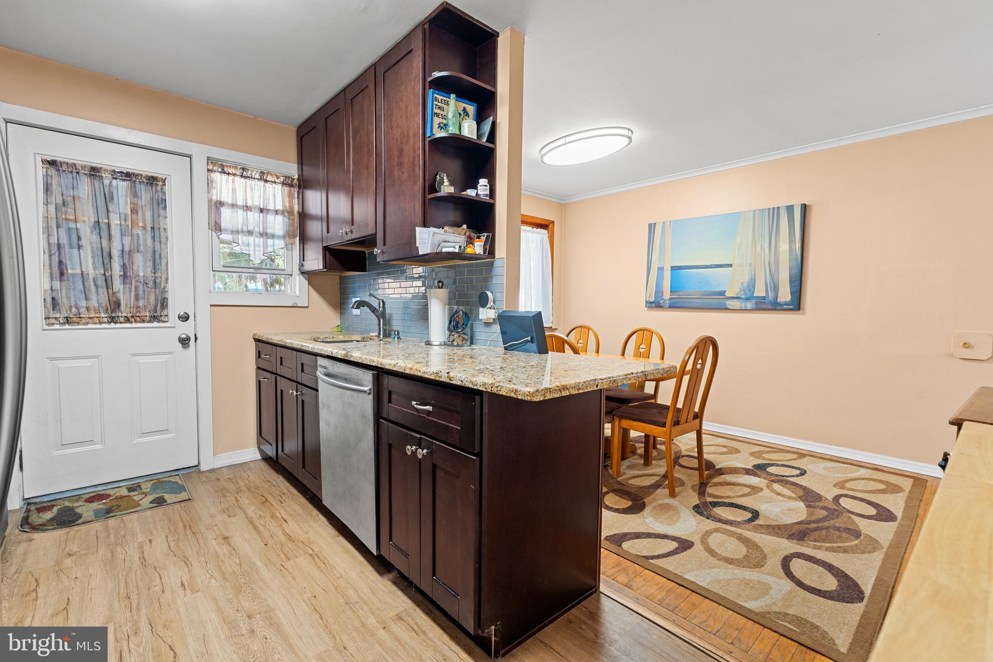 1614 Blackrock Road Swarthmore, PA 19081 - Photo 9 of 31 a kitchen with a table chairs and a refrigerator