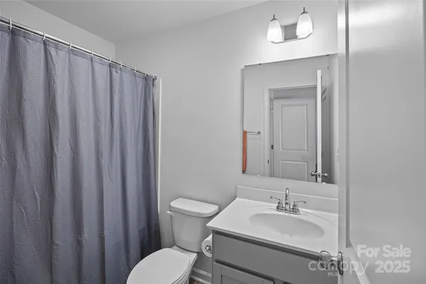 a bathroom with a sink a toilet and mirror