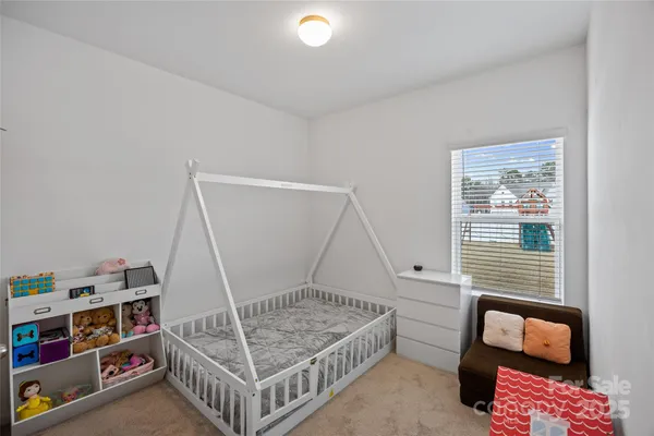 a bedroom with furniture and a window
