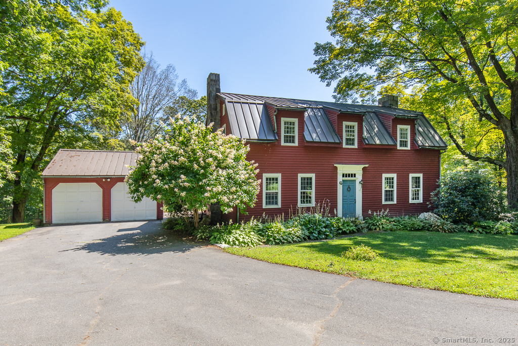 a front view of house with yard and trees