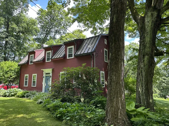 aerial view of a house with a yard and potted plants