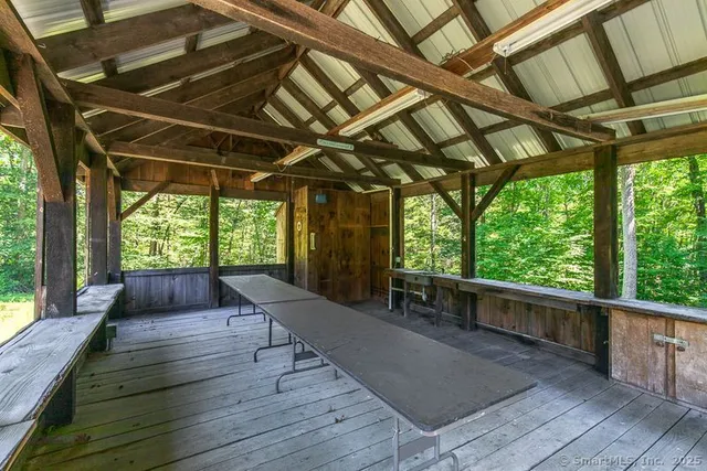 a room with large windows and wooden floor