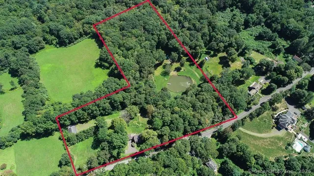 an aerial view of a house with a yard and garden