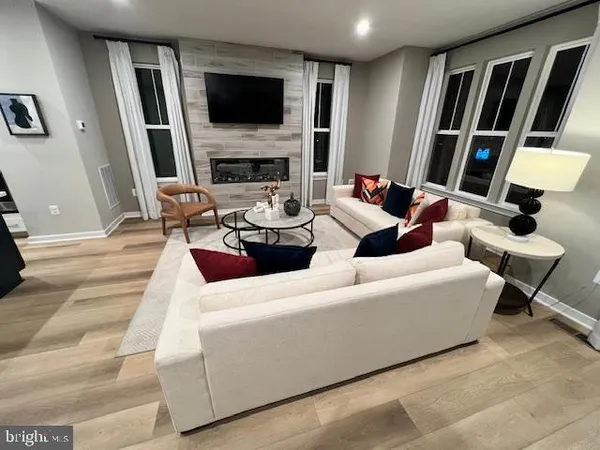 a living room with furniture fireplace and a flat screen tv