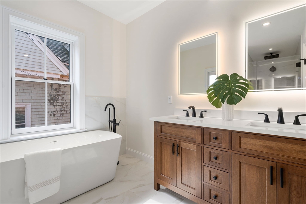 41 Waverly Street Brookline, MA 02445 - Photo 13 of 38 a bathroom with a granite countertop sink and a bathtub