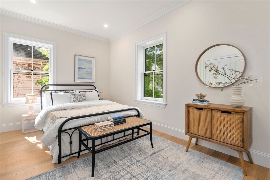 41 Waverly Street Brookline, MA 02445 - Photo 15 of 38 a bedroom with a bed a mirror and window
