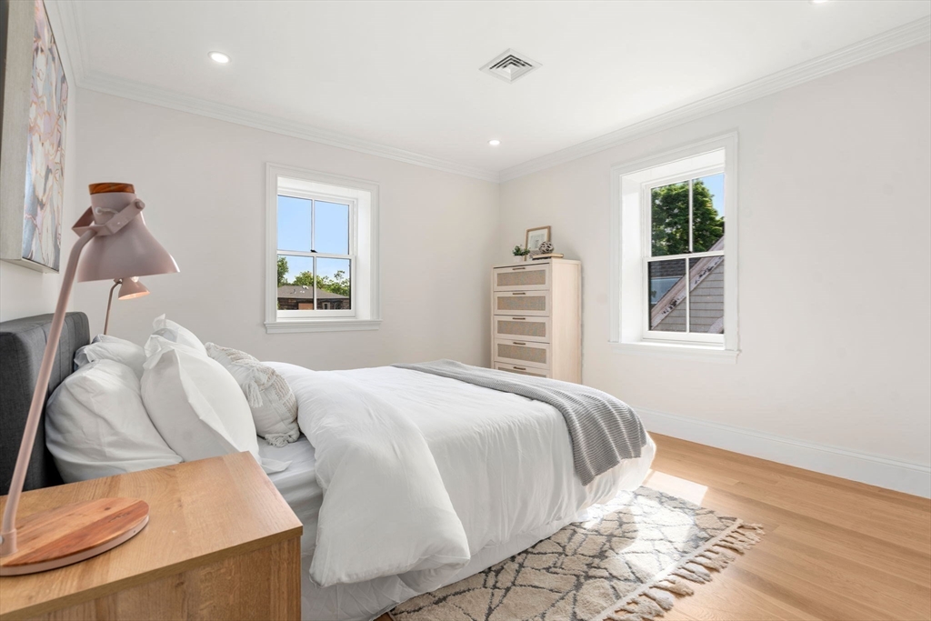 41 Waverly Street Brookline, MA 02445 - Photo 19 of 38 a bedroom with a bed and wooden floor