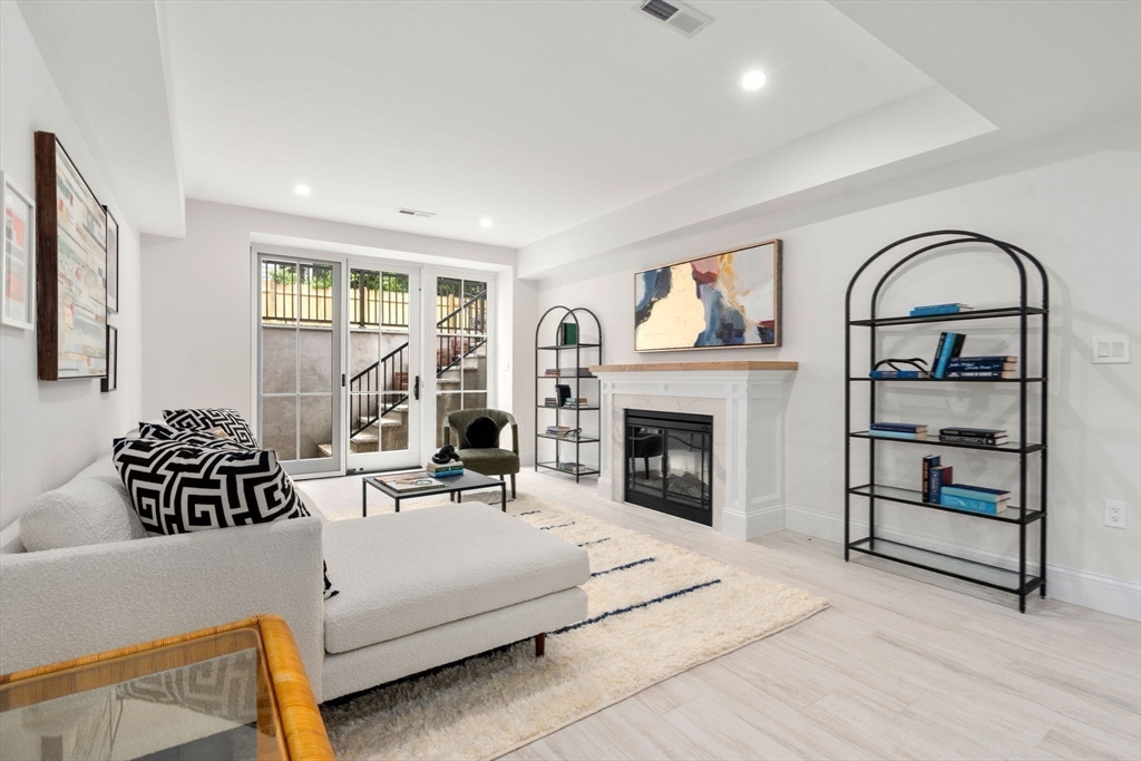 41 Waverly Street Brookline, MA 02445 - Photo 25 of 38 a living room with furniture a fireplace and a large window