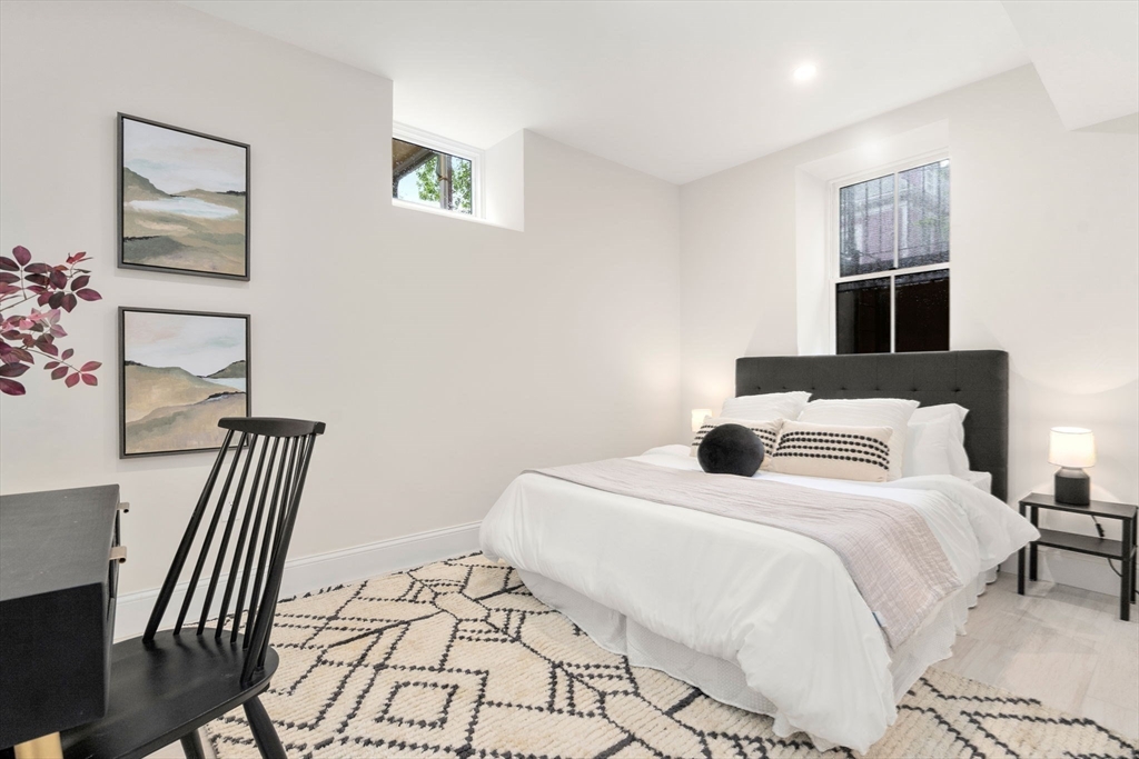 41 Waverly Street Brookline, MA 02445 - Photo 26 of 38 a bedroom with a bed and a table in it