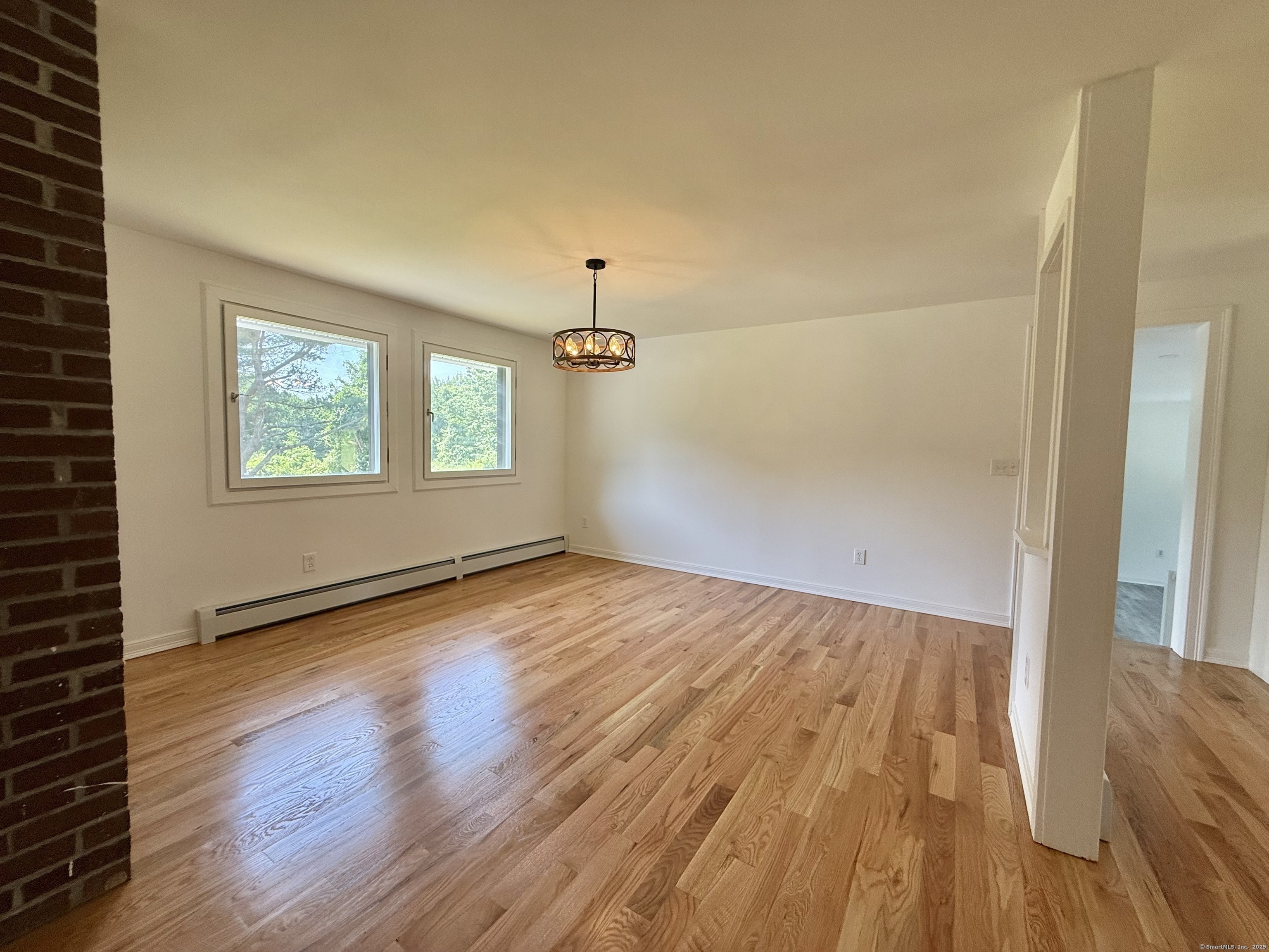 249 Wall Street Hebron, CT 06248 - Photo 15 of 28 wooden floor in an empty room with a window