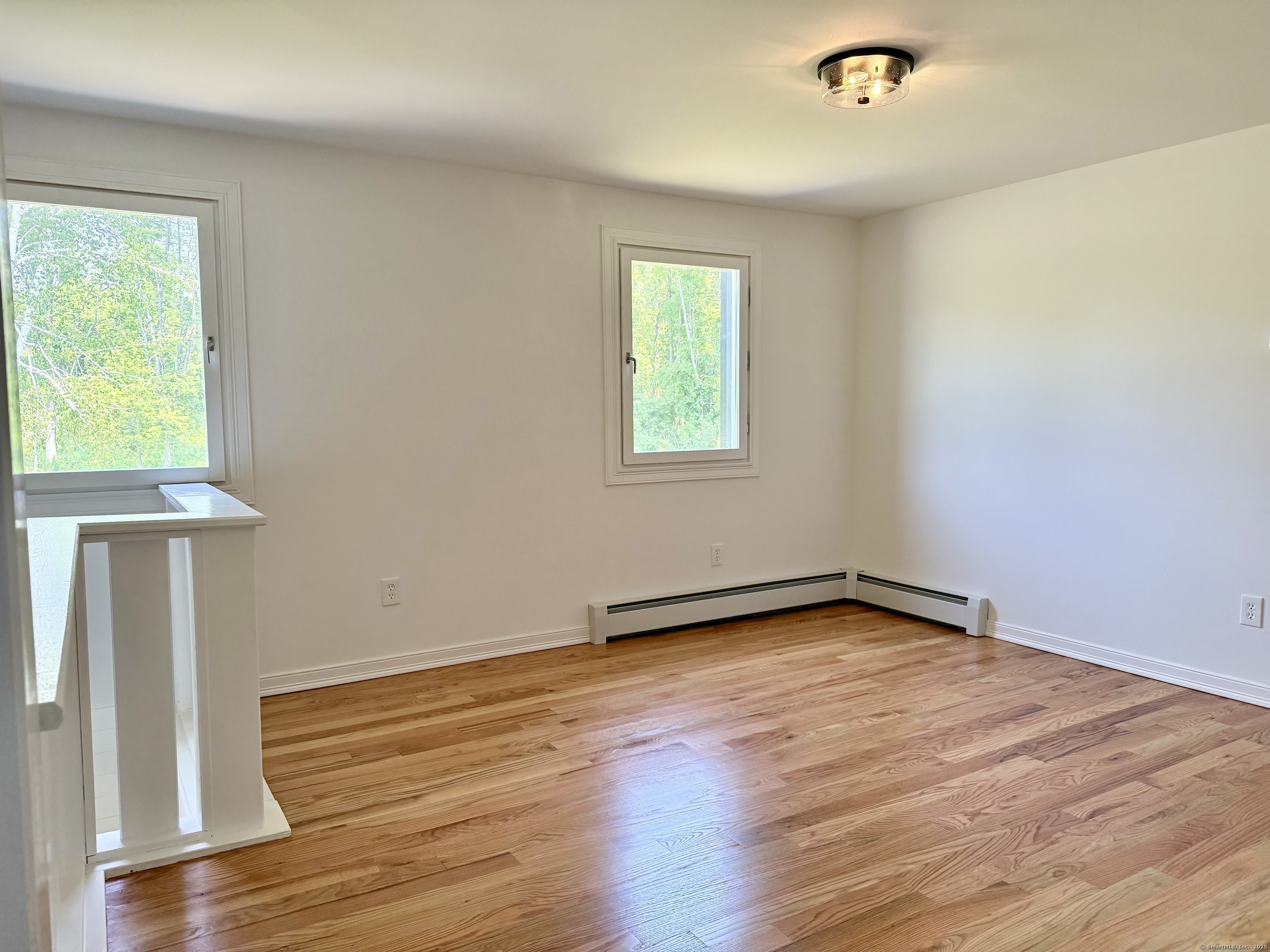 249 Wall Street Hebron, CT 06248 - Photo 19 of 28 an empty room with wooden floor and windows