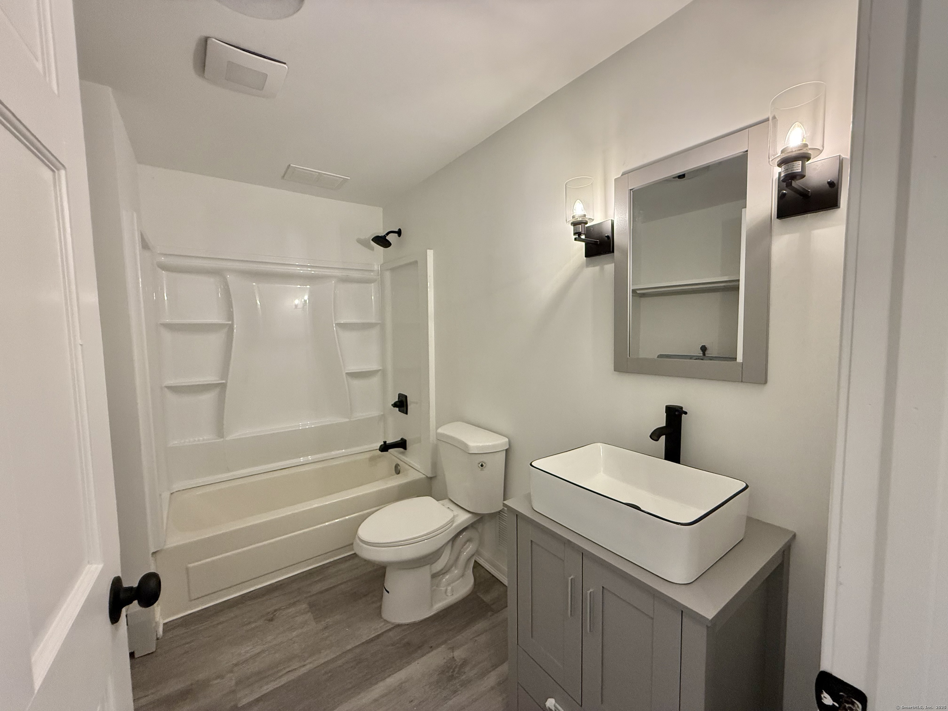 249 Wall Street Hebron, CT 06248 - Photo 23 of 28 a bathroom with a sink a toilet and shower