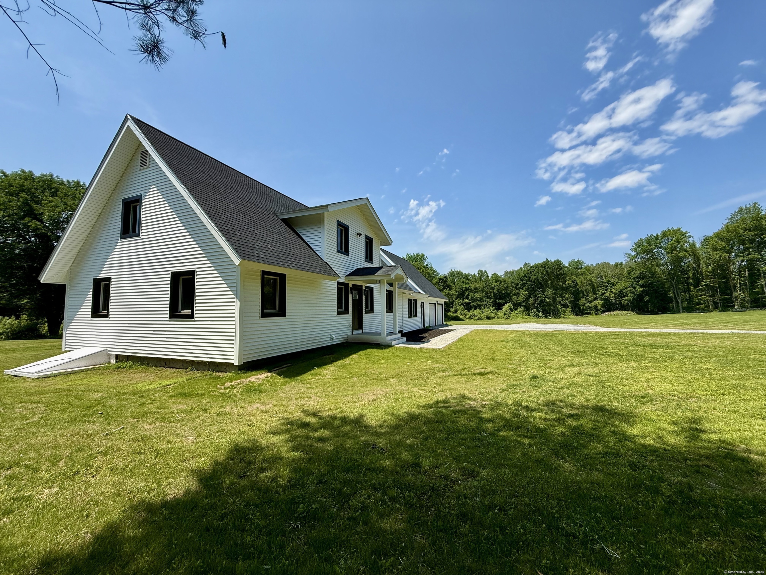 249 Wall Street Hebron, CT 06248 - Photo 28 of 28 a front view of house with yard and trees in the background