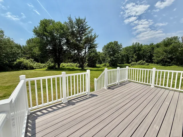 a balcony with wooden floor and fence