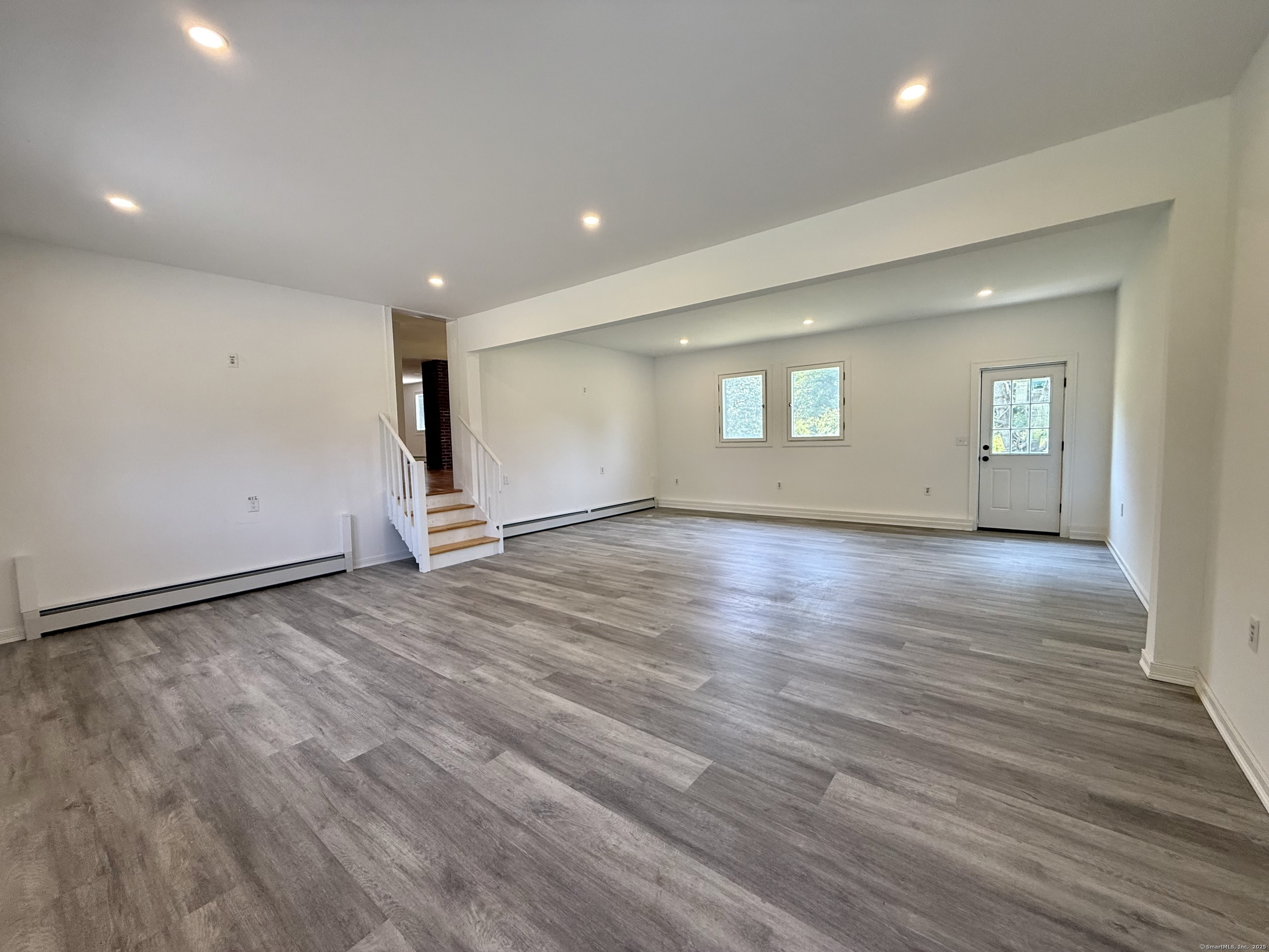 249 Wall Street Hebron, CT 06248 - Photo 9 of 28 an empty room with wooden floor and windows