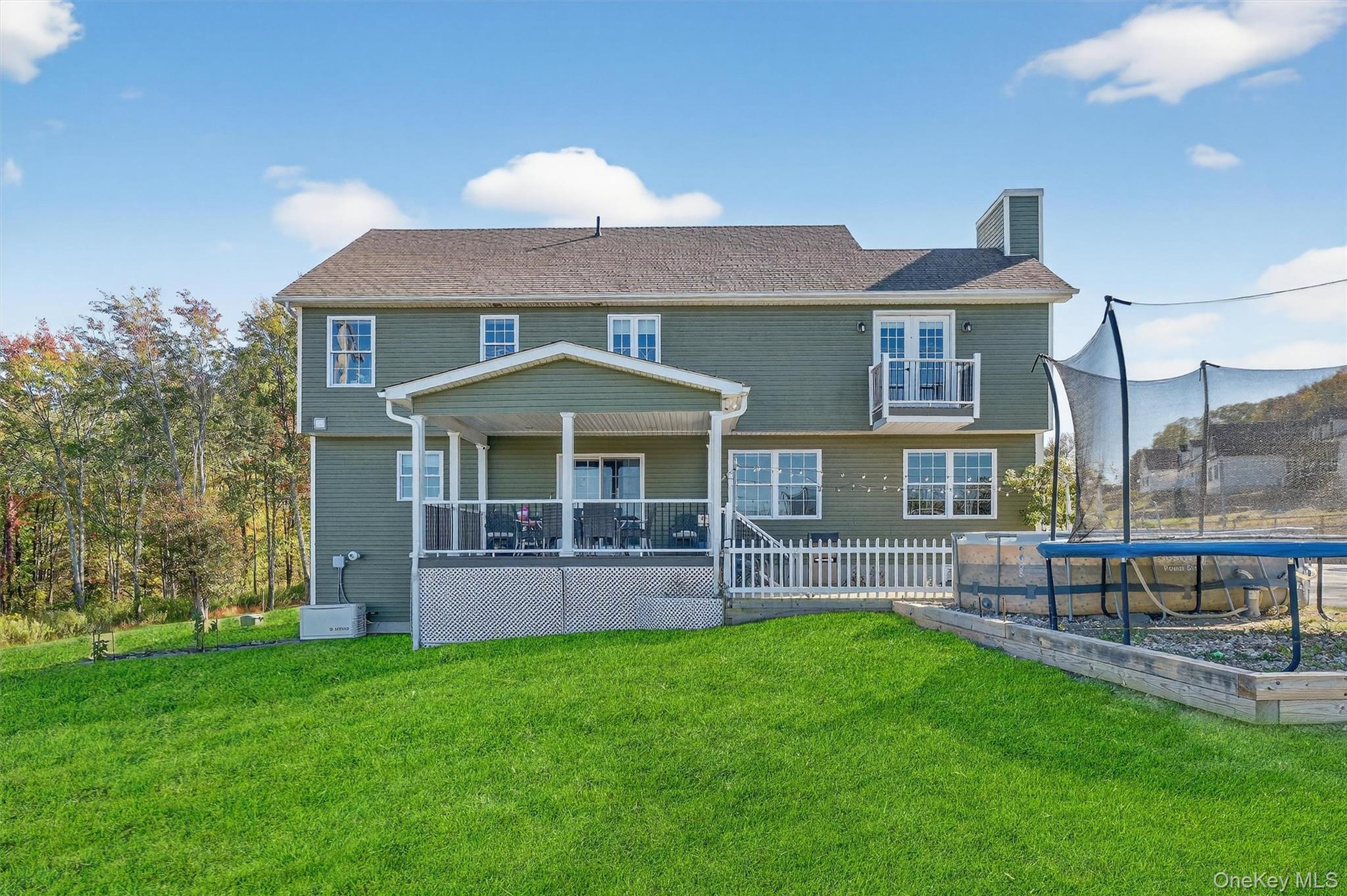 10 Domingues Road Newburgh, NY 12550 - Photo 21 of 30 Expansive backyard with a covered deck, white picket fencing, and a second-story Juliet balcony