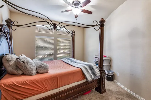 a bedroom with a bed and a mirror