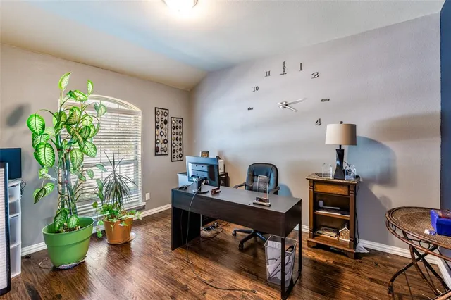 a workspace with furniture and a potted plant