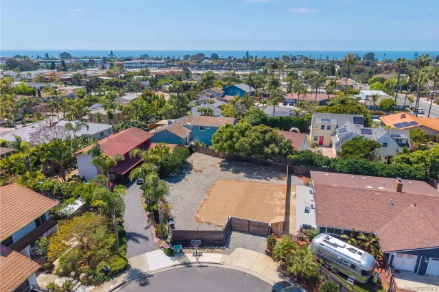 an aerial view of a houses with a city street