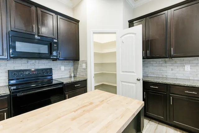 a kitchen with a refrigerator stove and sink