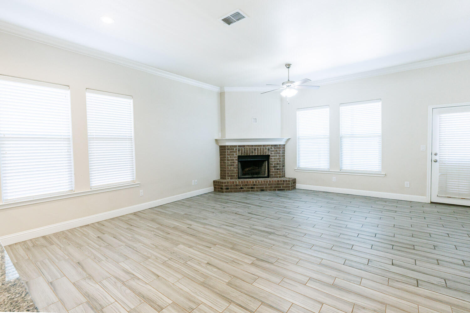 13801 Uvalde Avenue Lubbock, TX 79423 - Photo 15 of 46 an empty room with windows and a fireplace