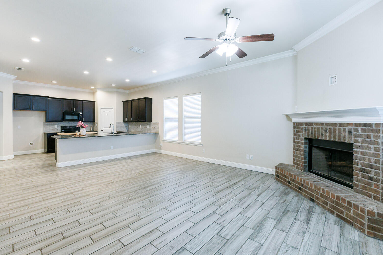 13801 Uvalde Avenue Lubbock, TX 79423 - Photo 18 of 46 a view of kitchen with microwave a stove and a refrigerator