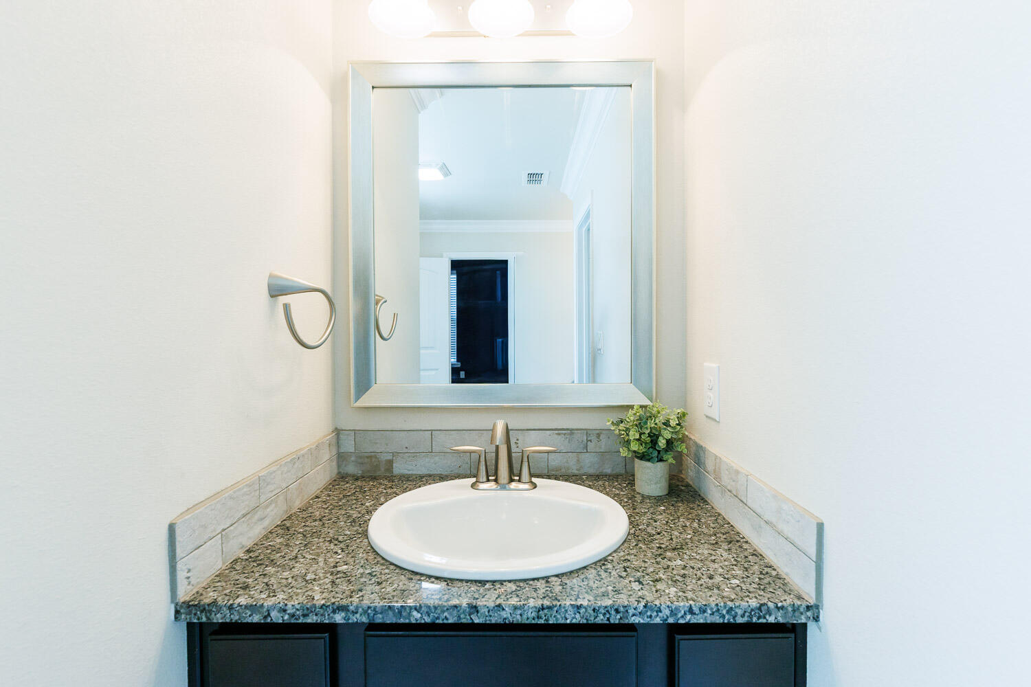 13801 Uvalde Avenue Lubbock, TX 79423 - Photo 24 of 46 a bathroom with a granite countertop sink and a mirror