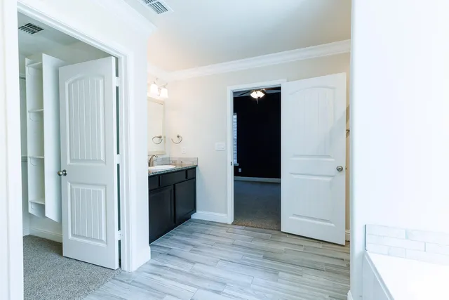 a spacious bathroom with a double vanity sink and a mirror