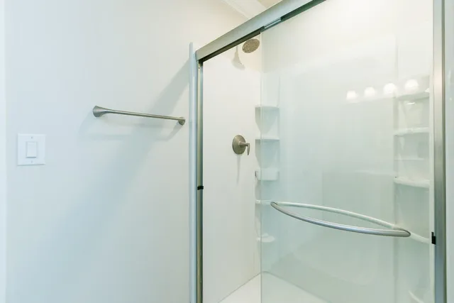 a bathroom with a glass shower door