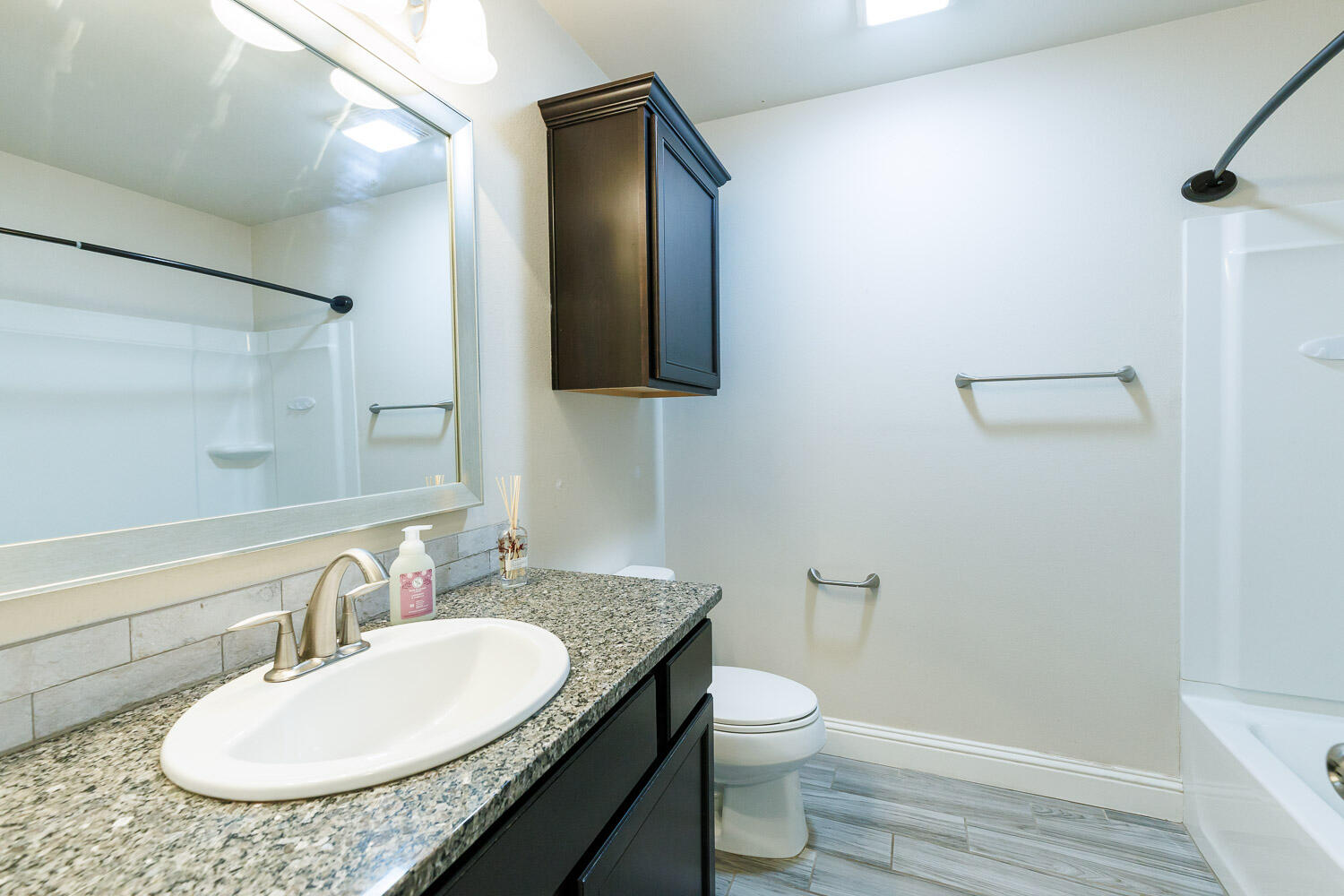 13801 Uvalde Avenue Lubbock, TX 79423 - Photo 37 of 46 a bathroom with a granite countertop sink and a mirror