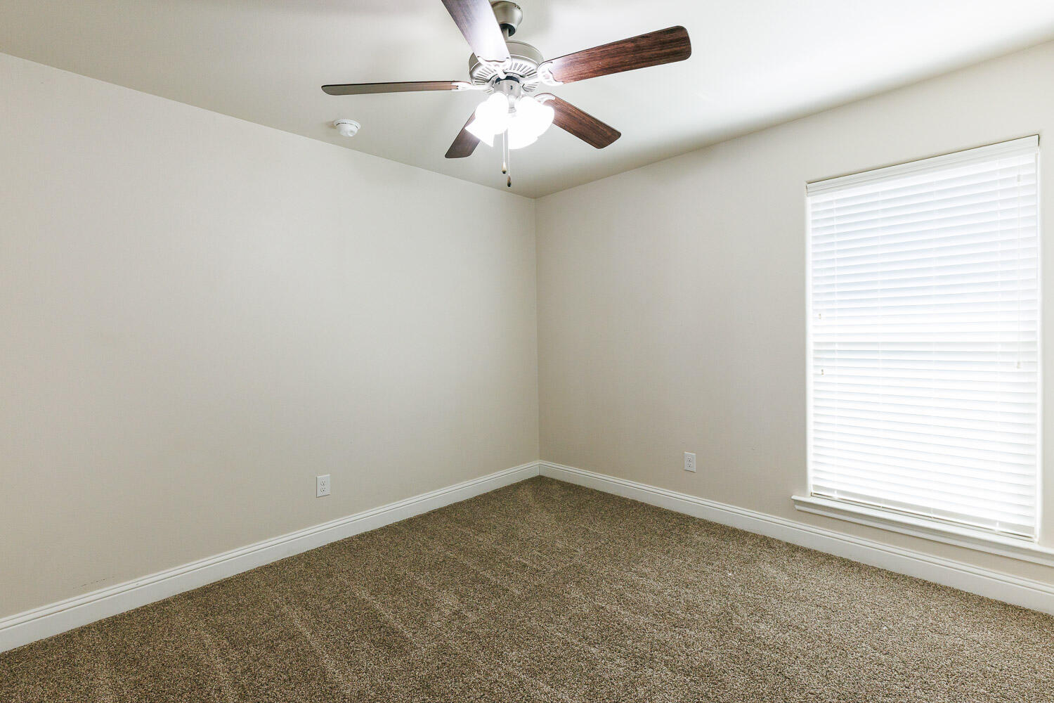 13801 Uvalde Avenue Lubbock, TX 79423 - Photo 40 of 46 an empty room with a window and a fan