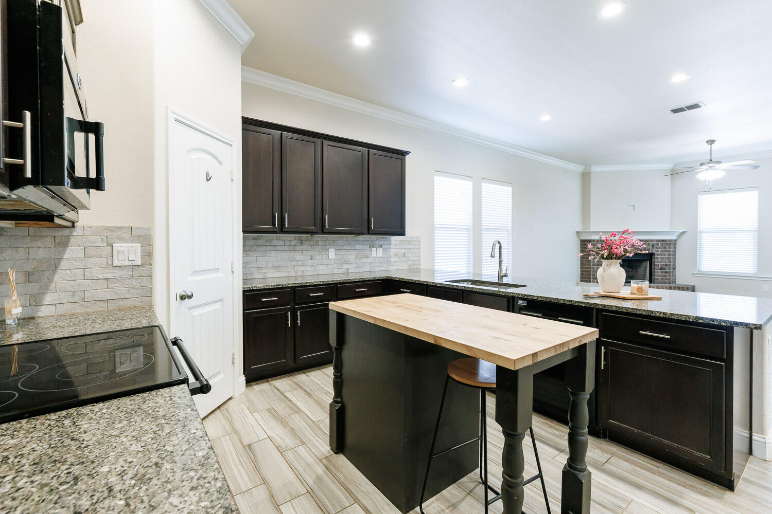 13801 Uvalde Avenue Lubbock, TX 79423 - Photo 7 of 46 a kitchen with stainless steel appliances granite countertop a sink and a stove