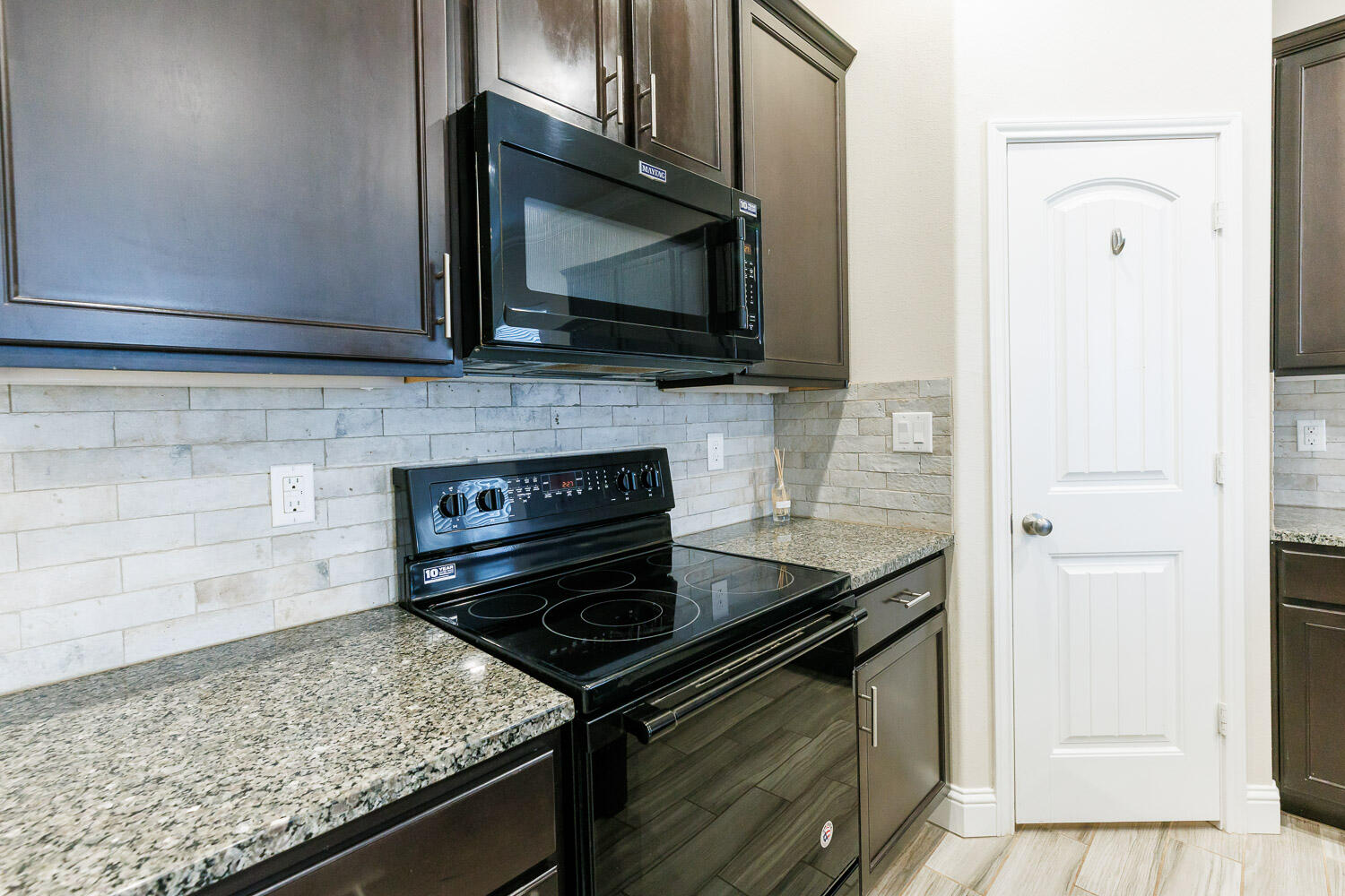 13801 Uvalde Avenue Lubbock, TX 79423 - Photo 8 of 46 a kitchen with a stove microwave and sink