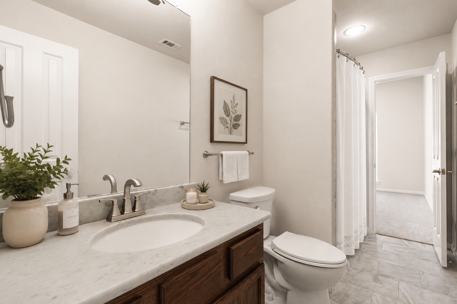 1100 Springbrook Road Pflugerville, TX 78660 - Photo 17 of 23 Marble vanity tops complement the spacious, well-lit bathroom, featuring elegant gray tile flooring. Photo has been virtually staged