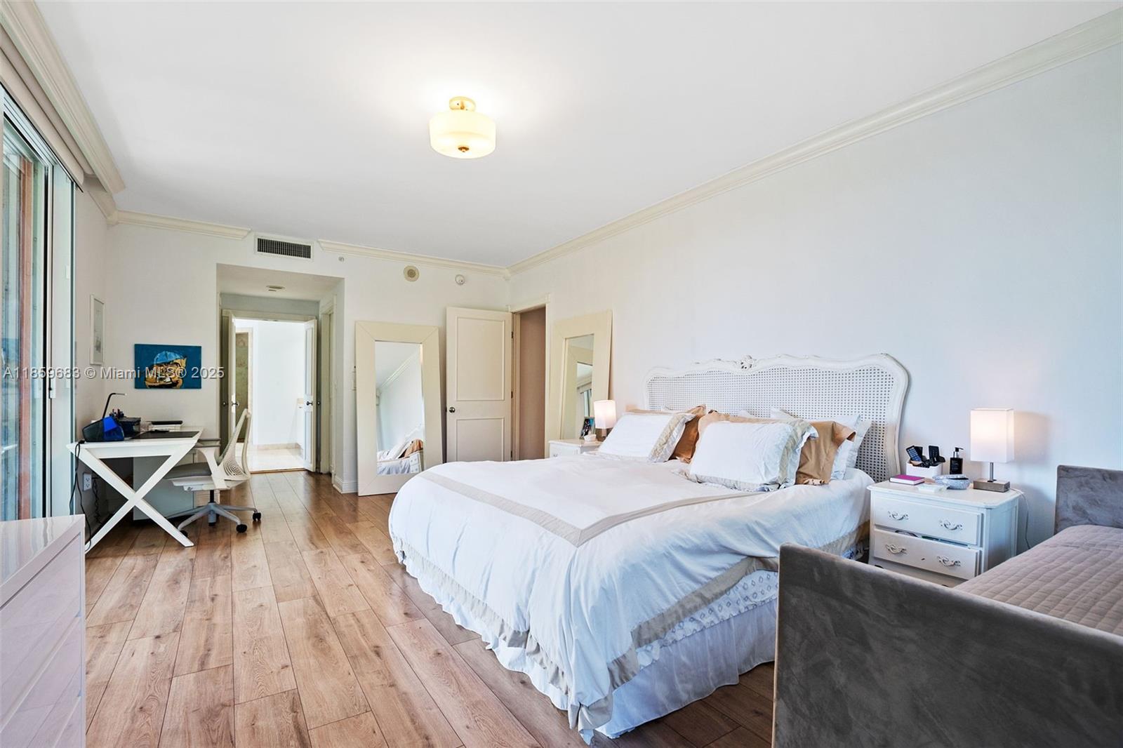 781 Crandon Boulevard, Unit 306 Key Biscayne, FL 33149 - Photo 13 of 32 a bedroom with a bed and wooden floor