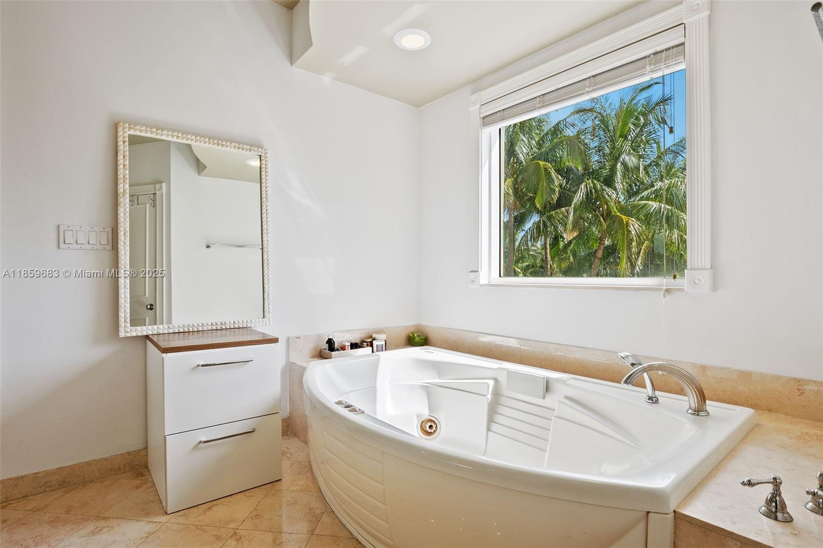 781 Crandon Boulevard, Unit 306 Key Biscayne, FL 33149 - Photo 15 of 32 a white bath tub sitting next to a window