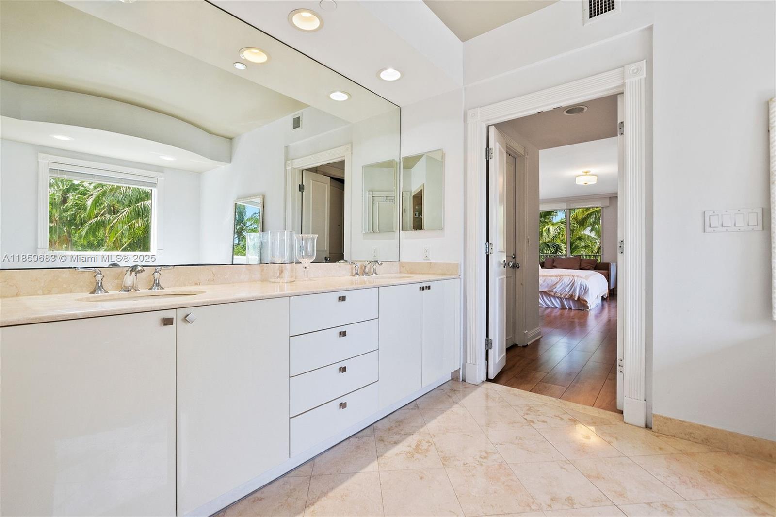 781 Crandon Boulevard, Unit 306 Key Biscayne, FL 33149 - Photo 16 of 32 a bathroom with a granite countertop sink mirror and bathtub