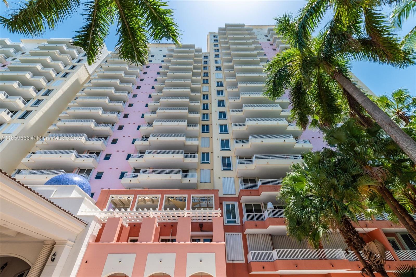 781 Crandon Boulevard, Unit 306 Key Biscayne, FL 33149 - Photo 2 of 32 a front view of multi story residential apartment building with yard and parking space